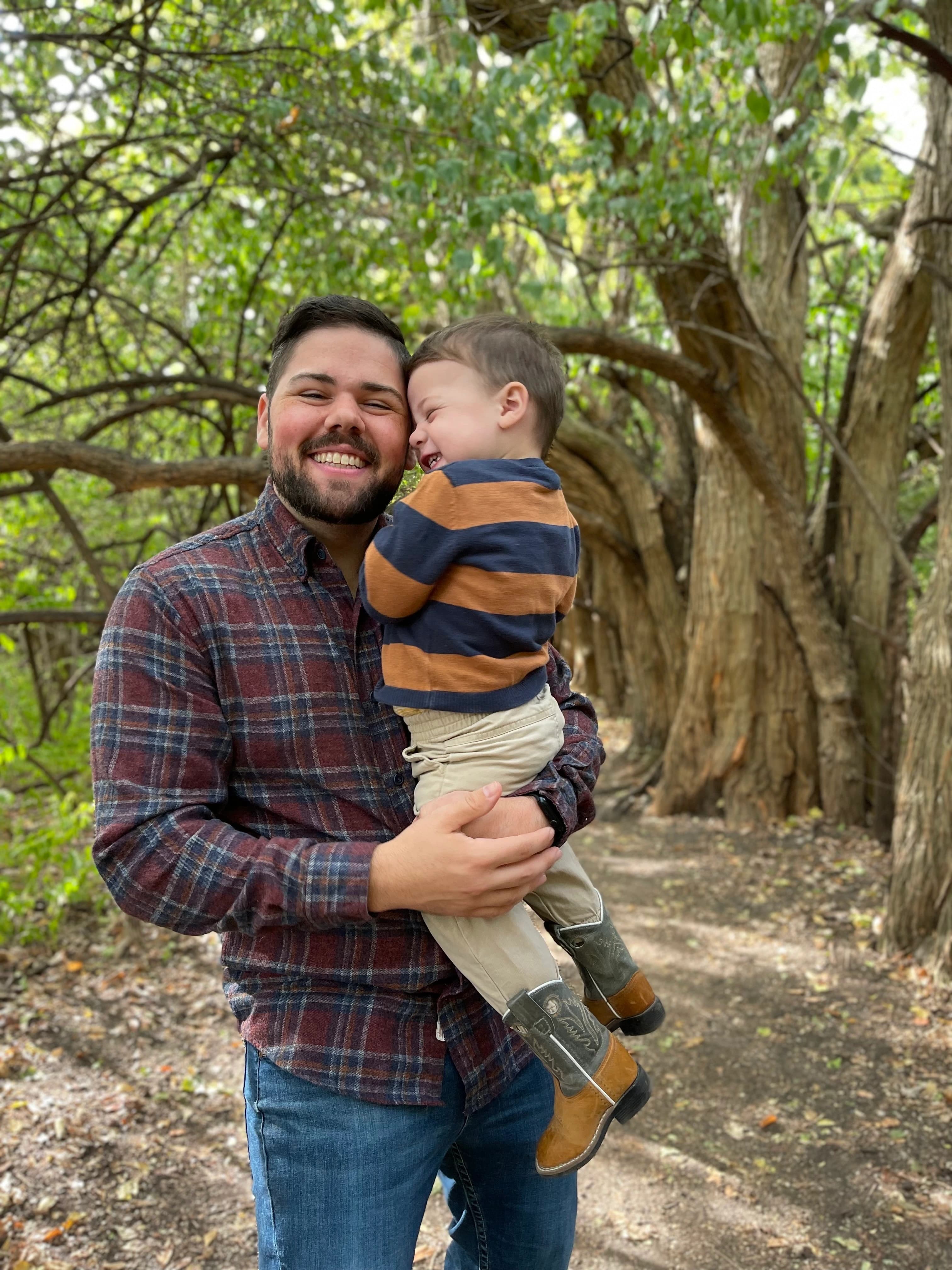 Photo of Taylor Clay holding his son